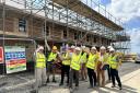 White Horse Housing Association staff, contractors and partners getting a first sight of some of the new homes after the protective covers were removed