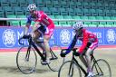 Sir Chris Hoy and Lauren cycle together during her trip to Manchester Velodrome