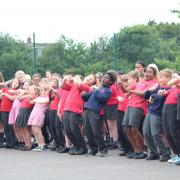 900 students and staff joined forces to perform song in BSL