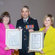 Homeline staff Mandy Blackford and Liz Watts received an award from Chief Fire Officer Ben Ansell for saving a resident's life