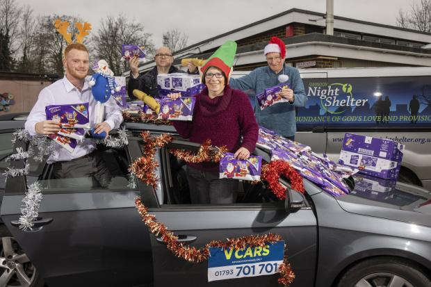 Jack Price from V Cars, Ian McCarthy from Swindon Nightshelter,  Diane Killick, Chairperson of Christmas Care, Swindon, and colleague John Davidson (C) HUW JOHN, Cardiff 02/12/2020