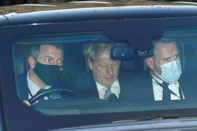 Prime Minister Boris Johnson (centre) leaves the Houses of Parliament in Westminster, London, as public anger continues following the leak on Monday of an email from the Prime Minister's principal private secretary Martin Reynolds inviting 100