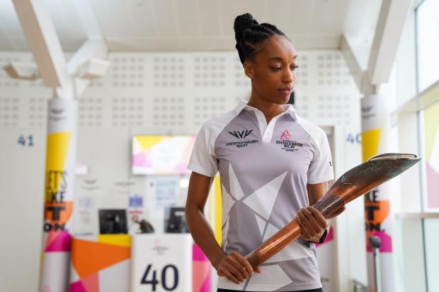 This Is Wiltshire: England netball international Layla Guscoth with the Commonwealth Games baton 