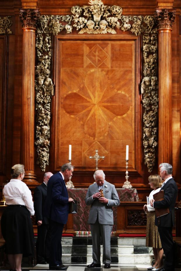 This Is Wiltshire: Prince Charles was shown the restored Grinling Gibbons Carvings at the College Chapel.