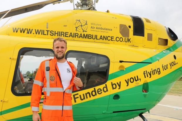 Swindon Town goalkeeper Lewis Ward with the Wiltshire Air Ambulance helicopter