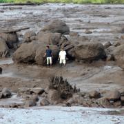 People inspect an area affected by flash flood in Agam, West Sumatra (Ali Nayaka/AP)