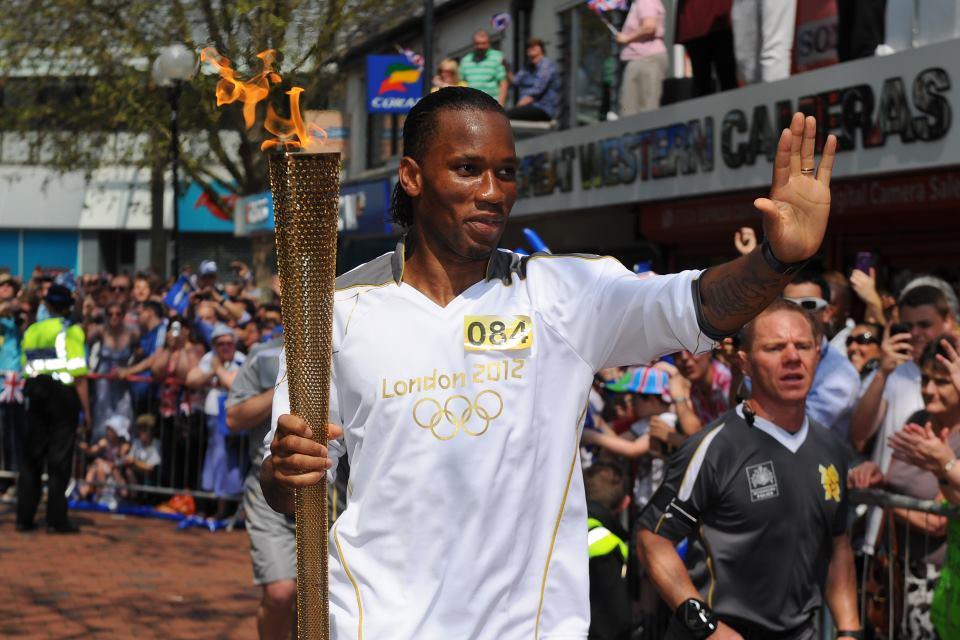 Champion: Chelsea's Didier Drogba carries the Olympic Flame through Swindon