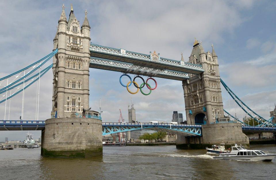 The Olympic Rings hang from Tower Bridge to mark one month to go to London 2012...